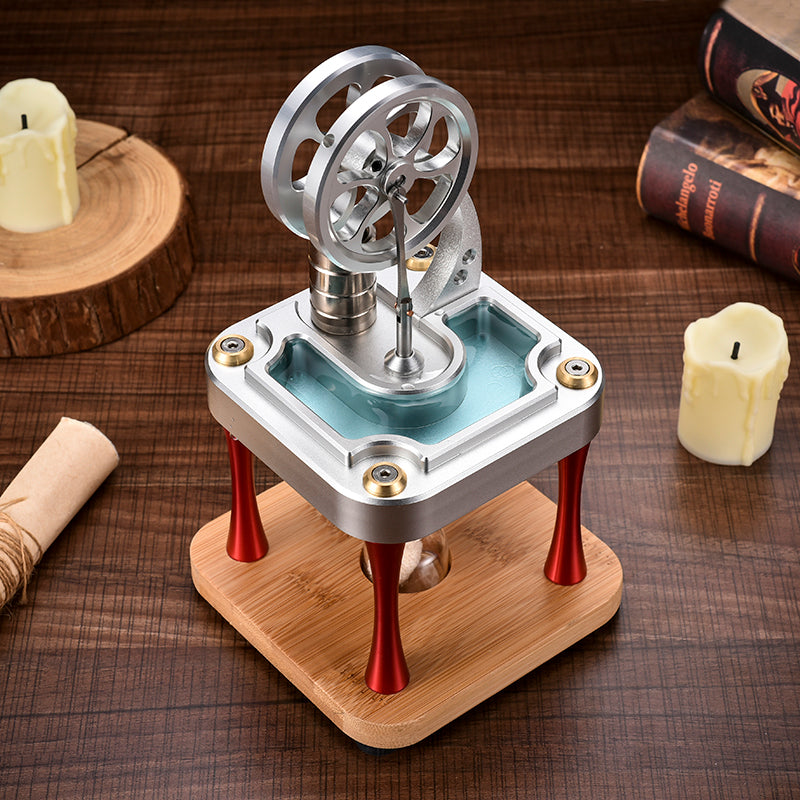 Metal Stirling engine with a water-filled top plate on red legs and a bamboo base