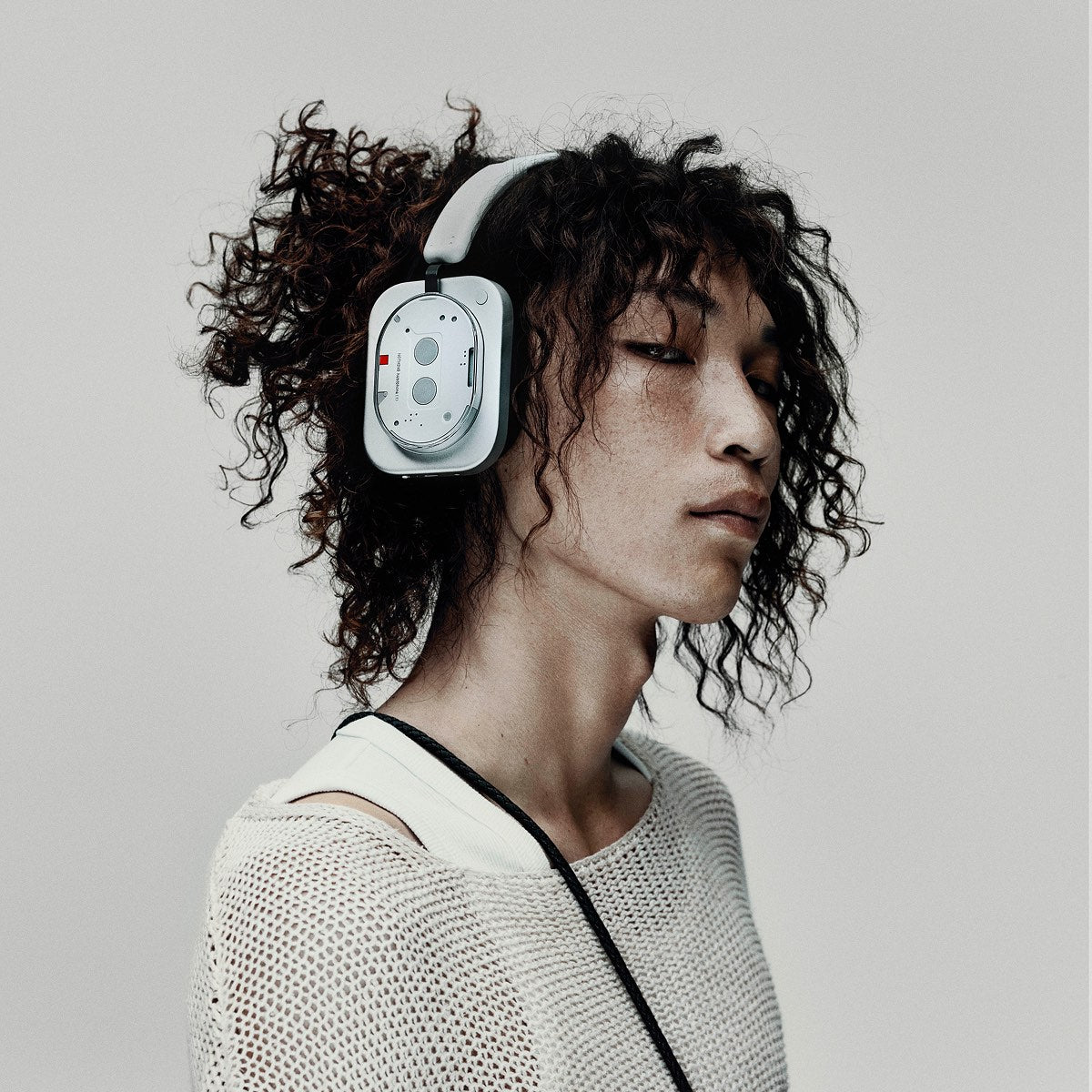 Person wearing the white Headphone (1) against a light gray backdrop
