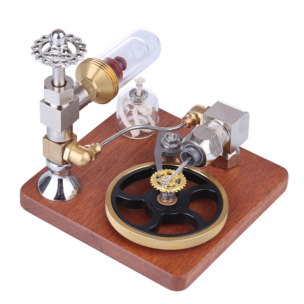 Stirling engine model on a reddish wooden base, with the glass cylinder and oil lamp at the left