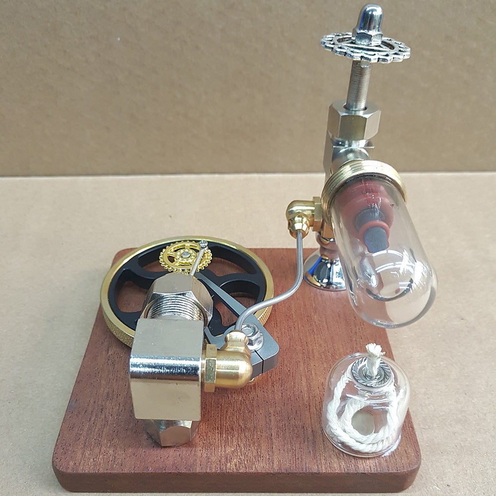Stirling engine model from the back, showing the glass cylinder and the oil lamp