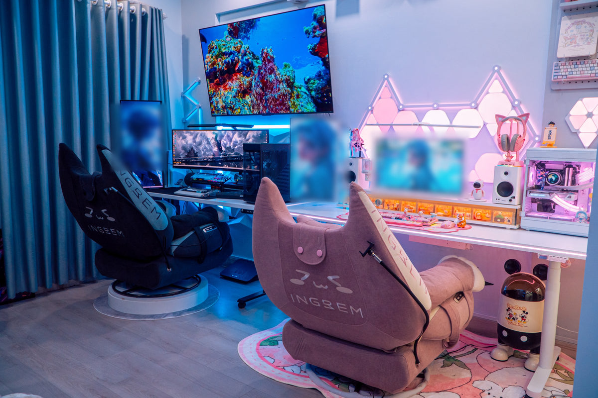 Wide room view with a pink recliner at a white desk and a second dark gaming workstation by the curtains