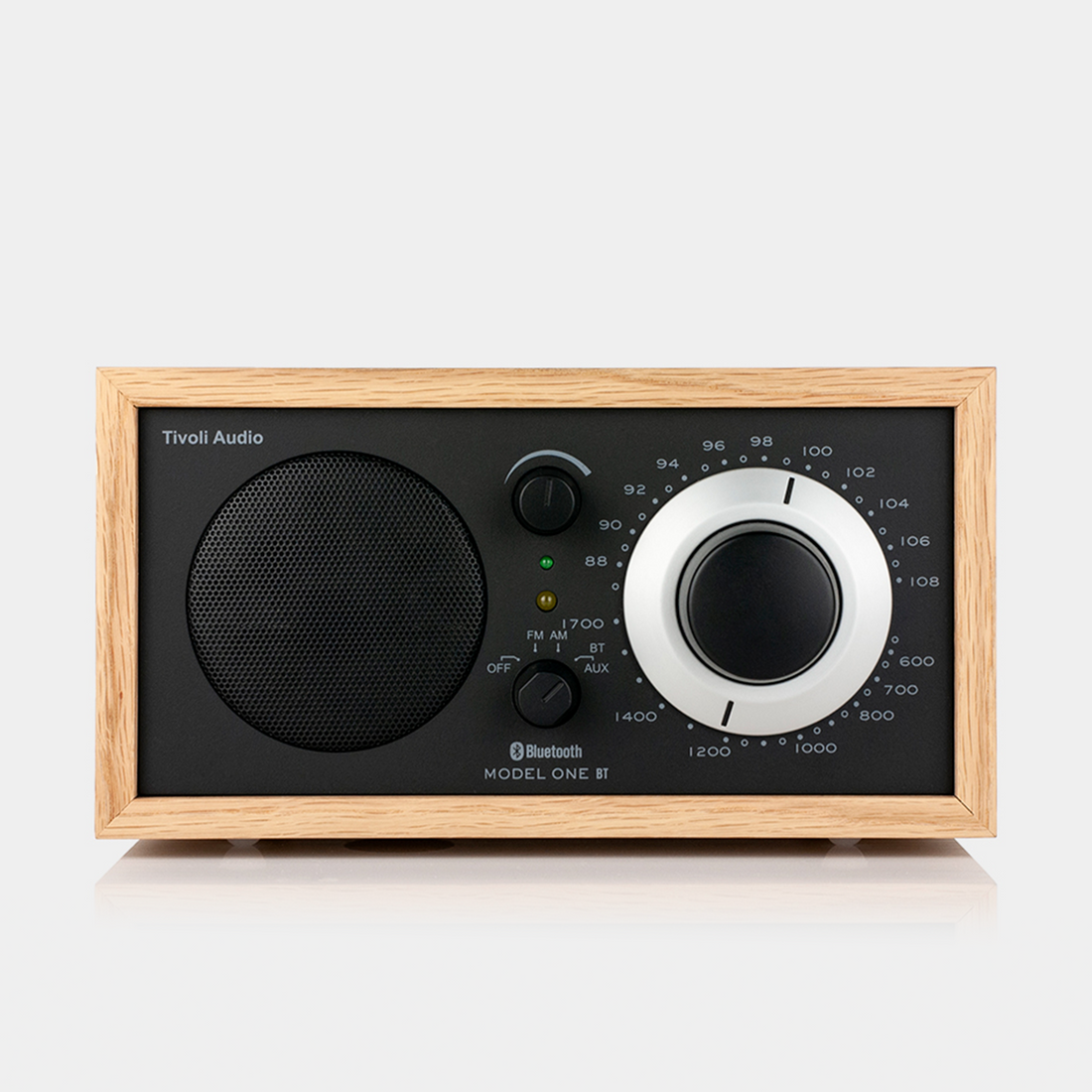 Oak cabinet radio with a black face and silver dial ring