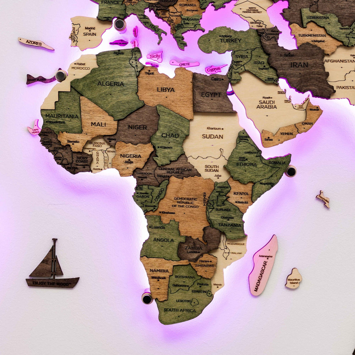 Africa and Europe on the wooden map with a purple backlight around the edges