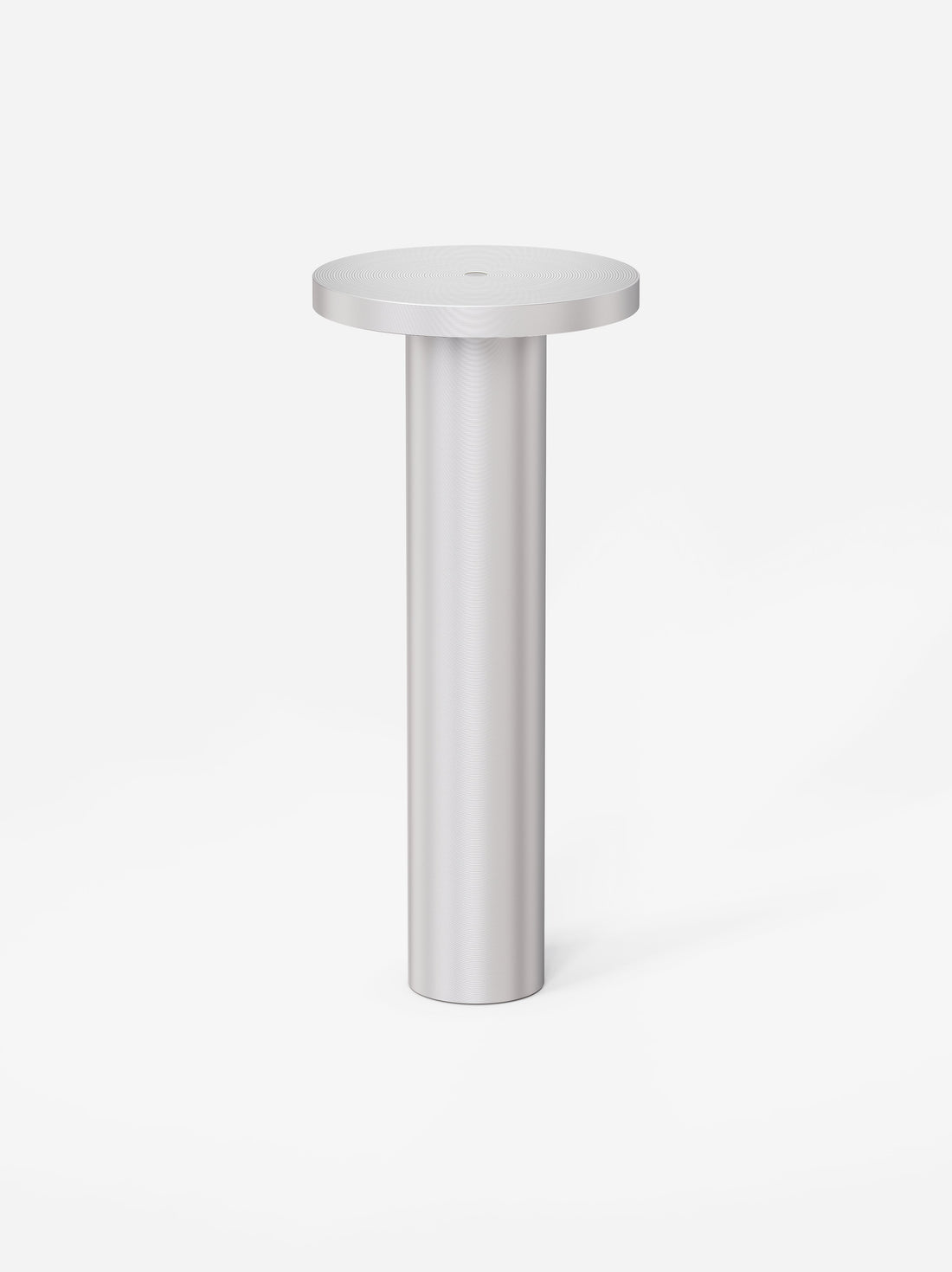 The silver anodized Luci lamp on a light grey background