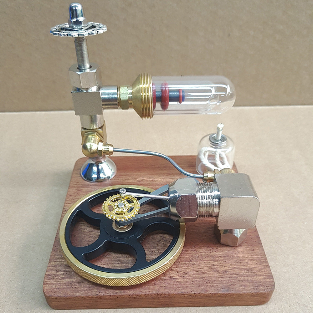 Stirling engine model with black flywheel and gold edge, front view