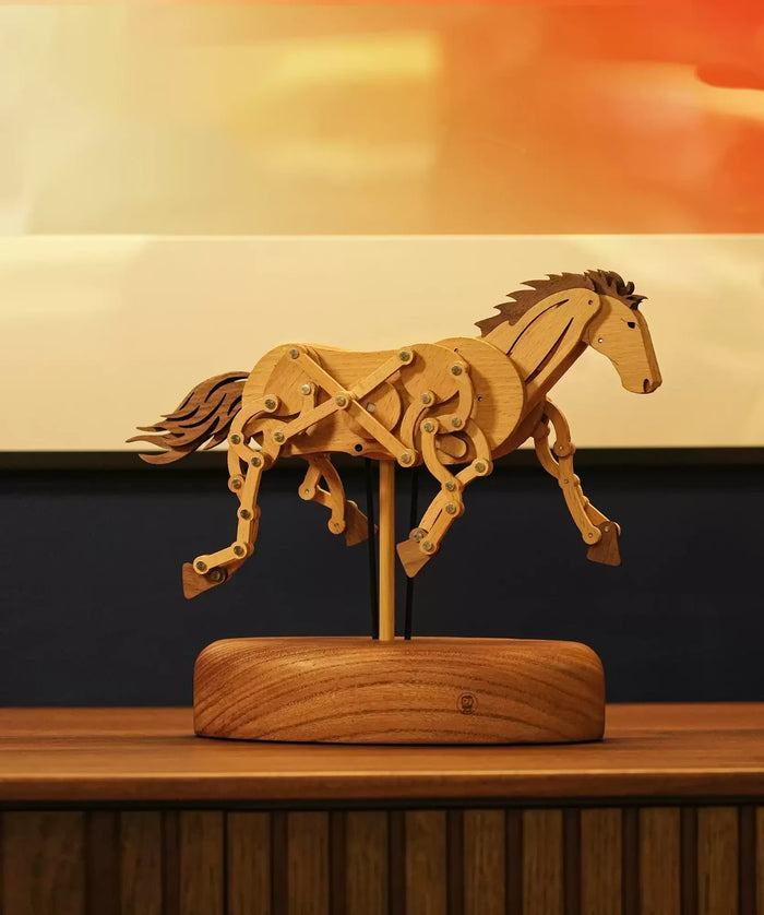 Farstride horse mid-gallop on its round base on a wooden sideboard, a sunset painting behind