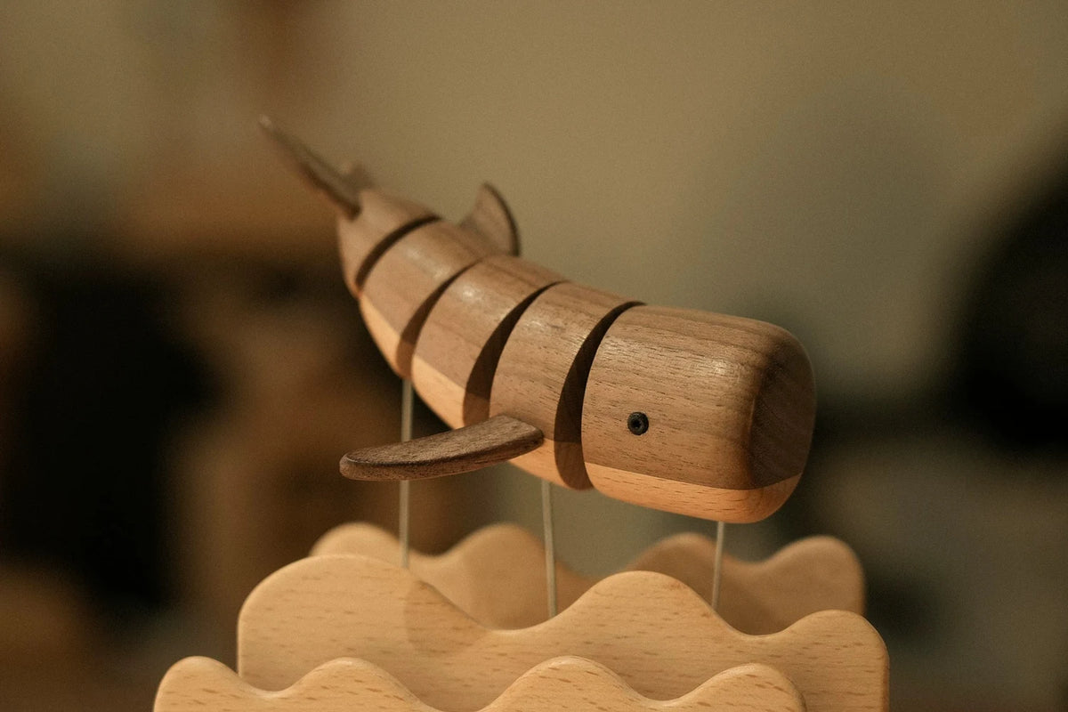 Close view of the striped whale, dark and light wood bands, above the wavy beech edge.